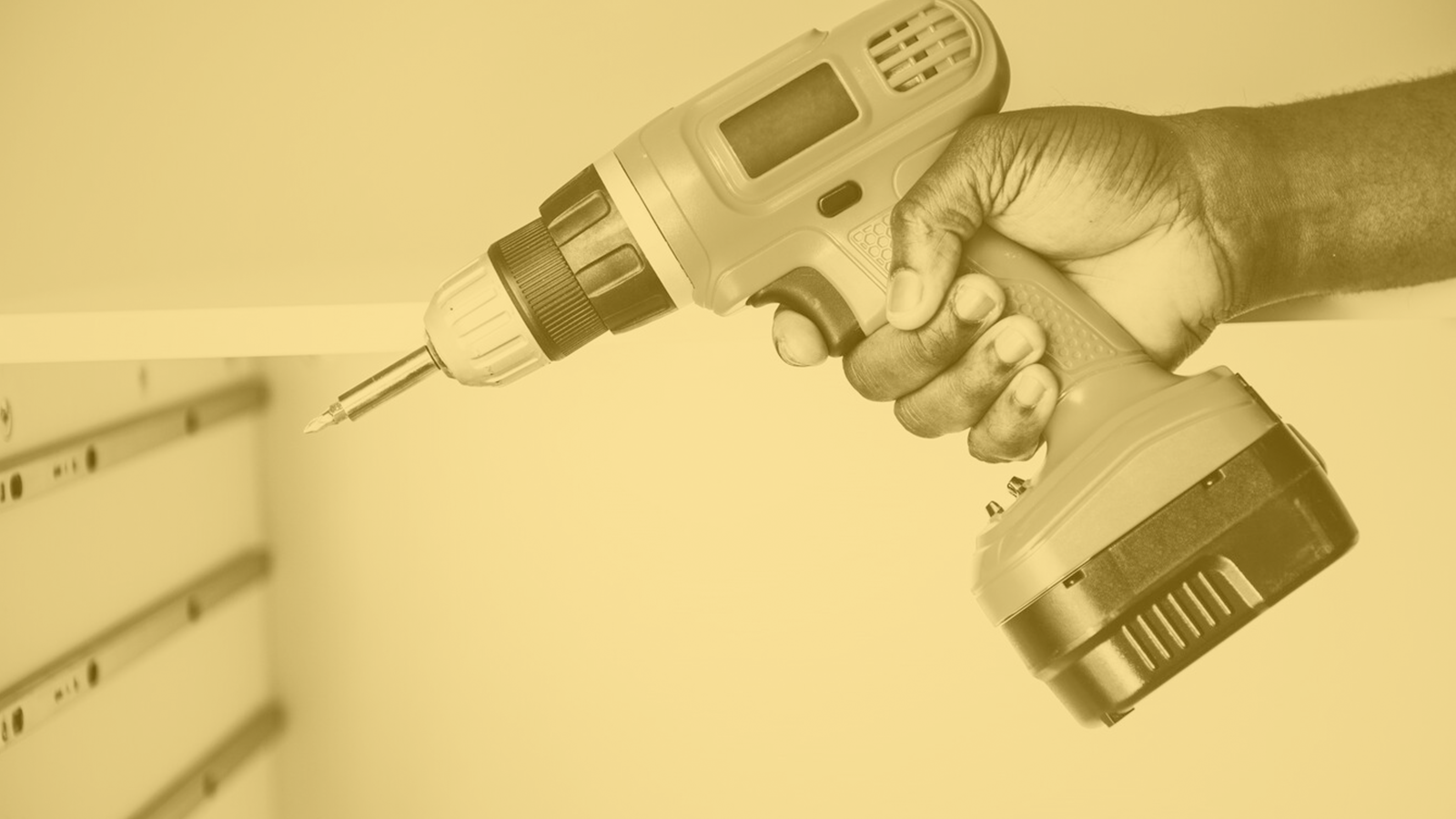 Man using an electric drill to secure cabinetry