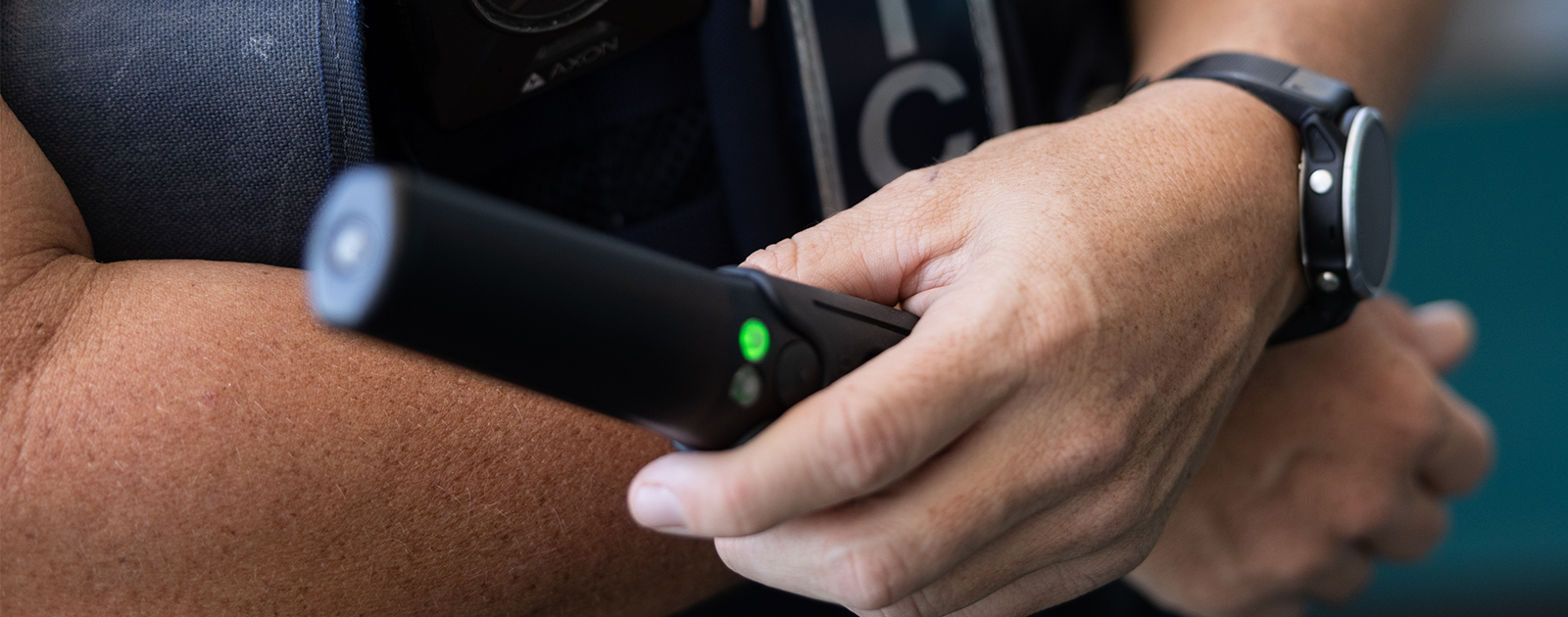 NT Police Officer holding a handheld scanner (wand).